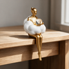 Nordic Girl Keepsake Statuette - Holding The Ball on wood surface