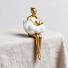Nordic Girl Keepsake Statuette - Holding The Ball on linen surface