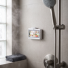 Waterproof phone holder mounted on a tiled shower wall
