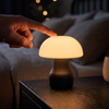 Finger tapping the top of the mushroom LED touch lamp to turn it on