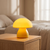 Mushroom LED touch lamp in sunny yellow on a wooden nightstand